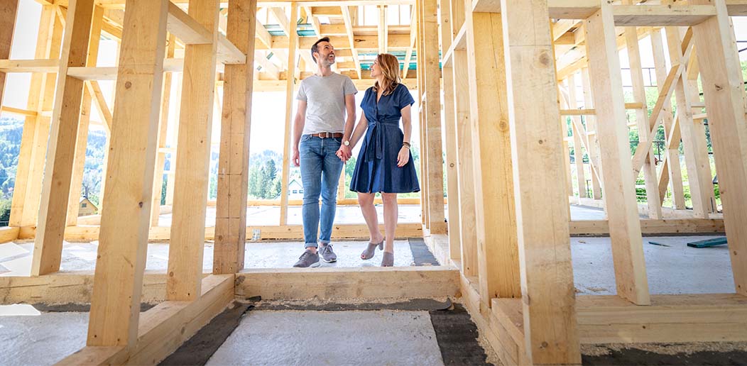 a couple exploring the build site for their new home
